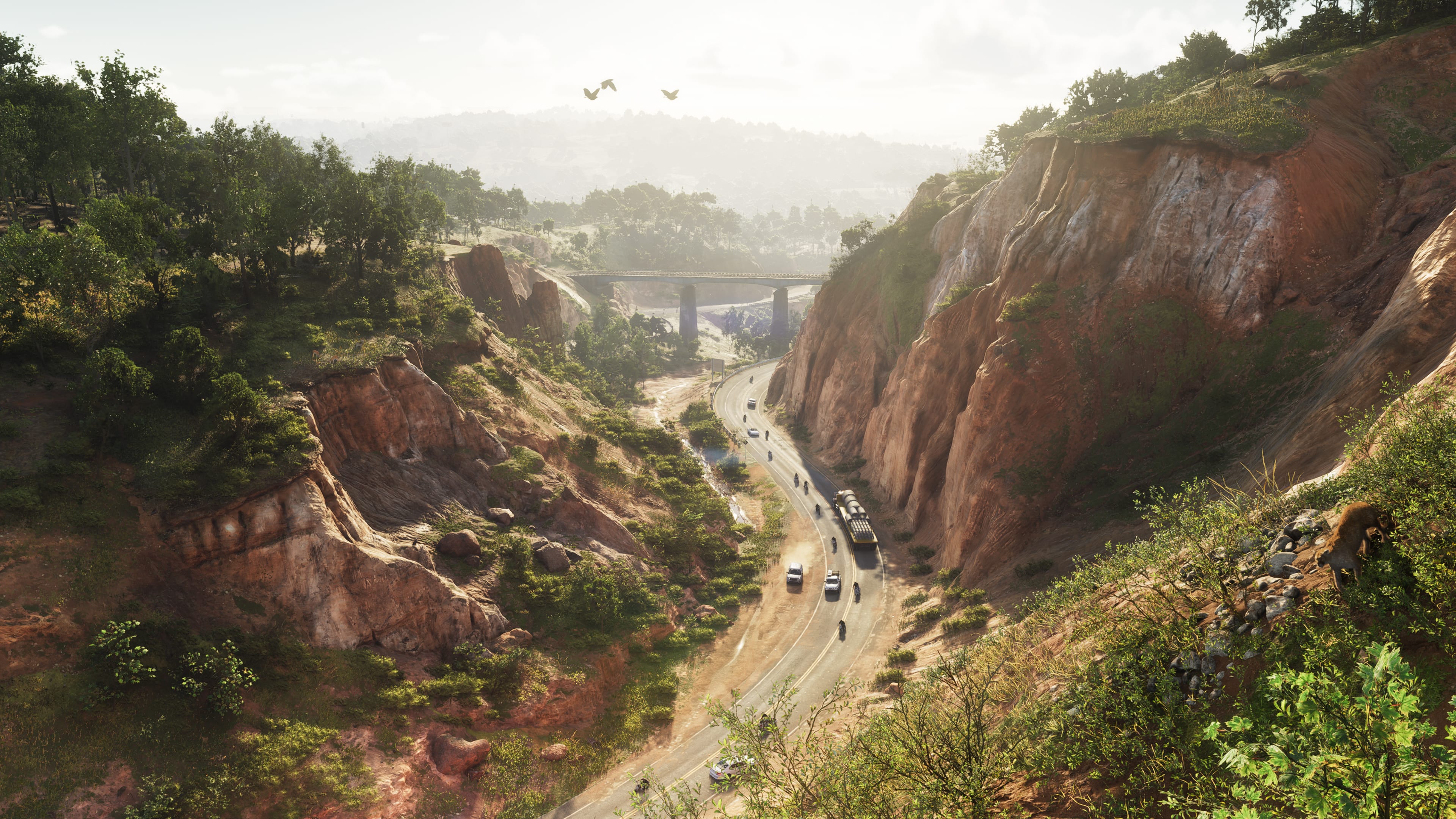 Cars drive down a valley highway in Mount Kalaga in GTA 6.