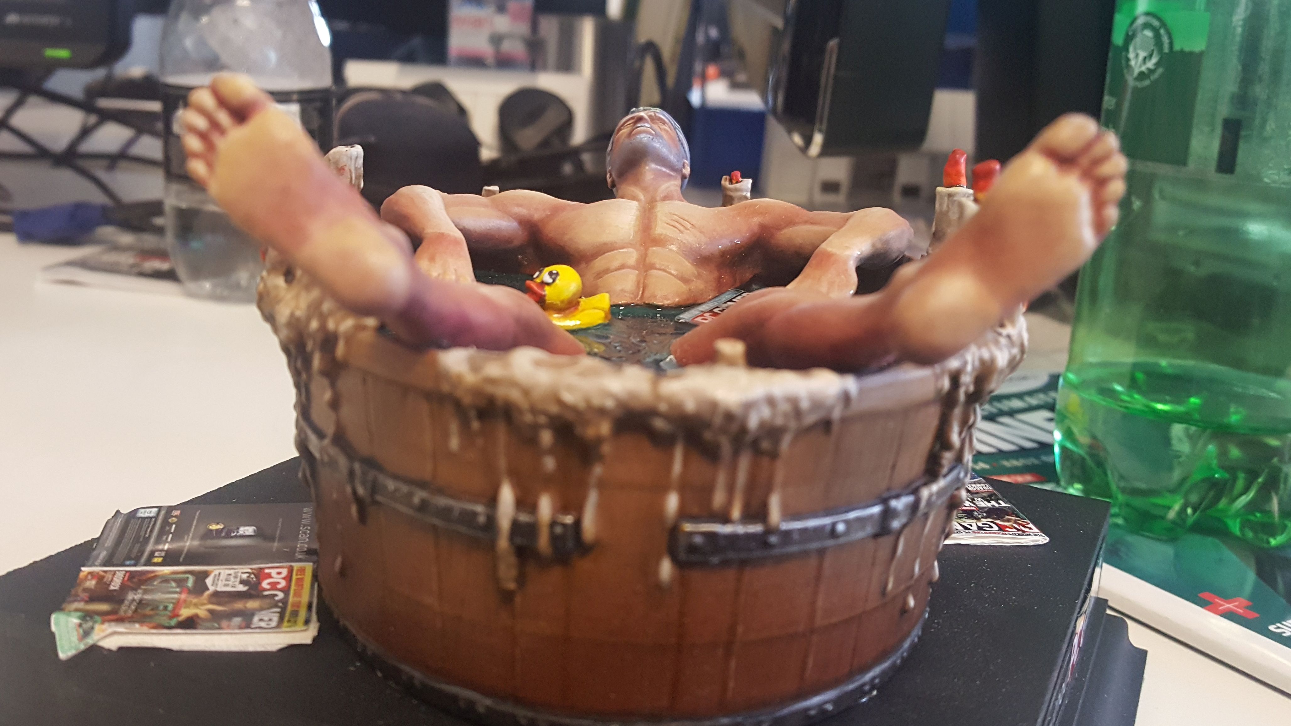 Geralt in a bathtub, but it's a statue.