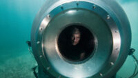 OceanGate CEO Stockton Rush peering through viewport