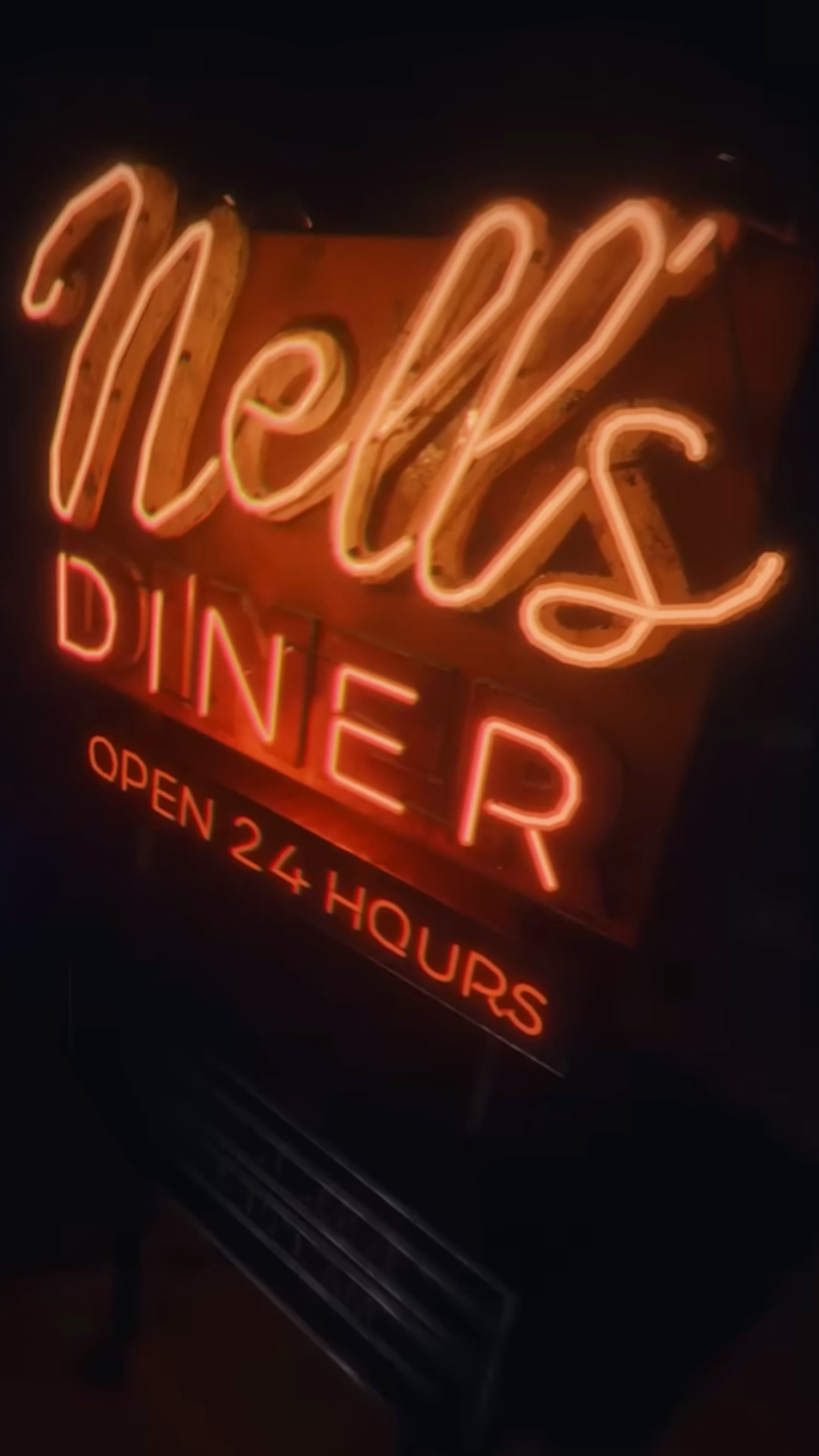 The Nell's Diner neon sign logo with "open 24 hours" at the bottom from the game Phasmophobia