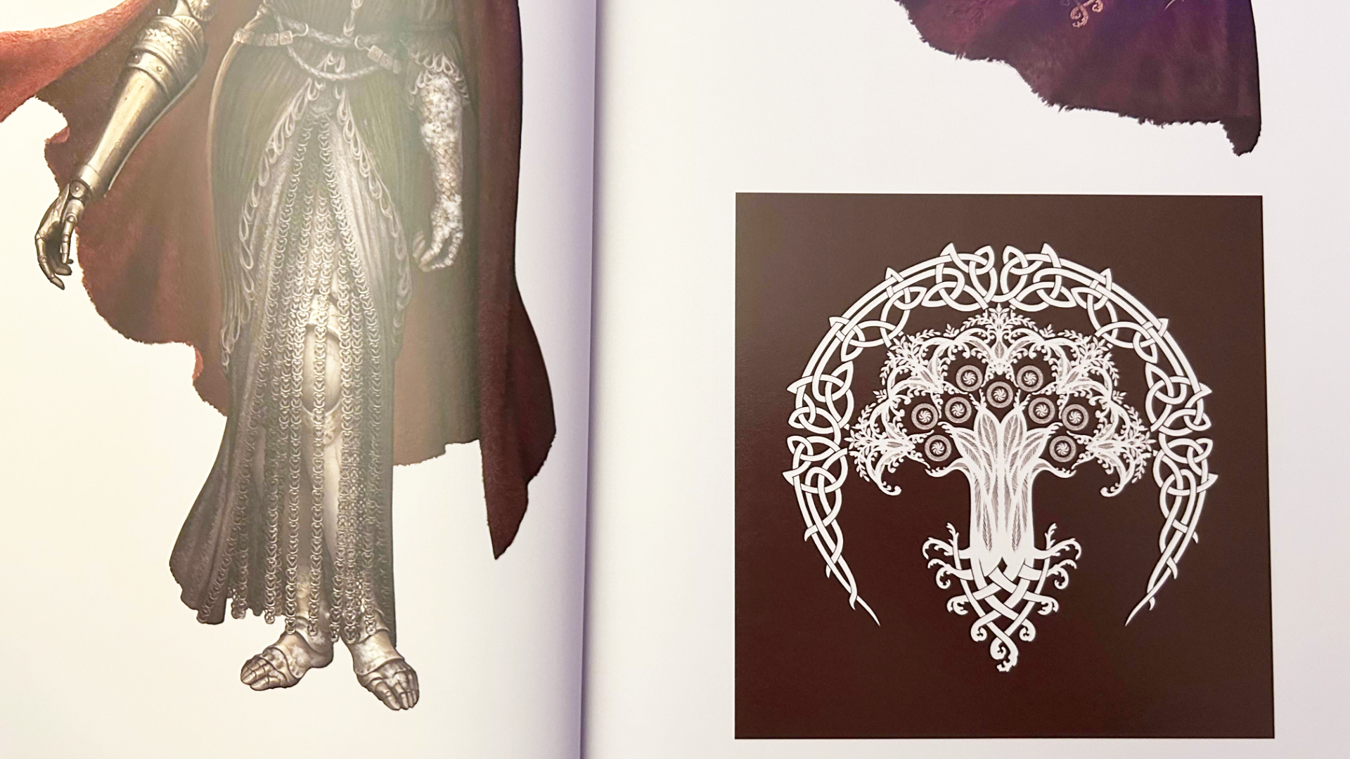 A photo of an Elden Ring concept art book. The bottom half of a red-haired valkyrie woman is on the left page. On the right page is a red tree insignia.