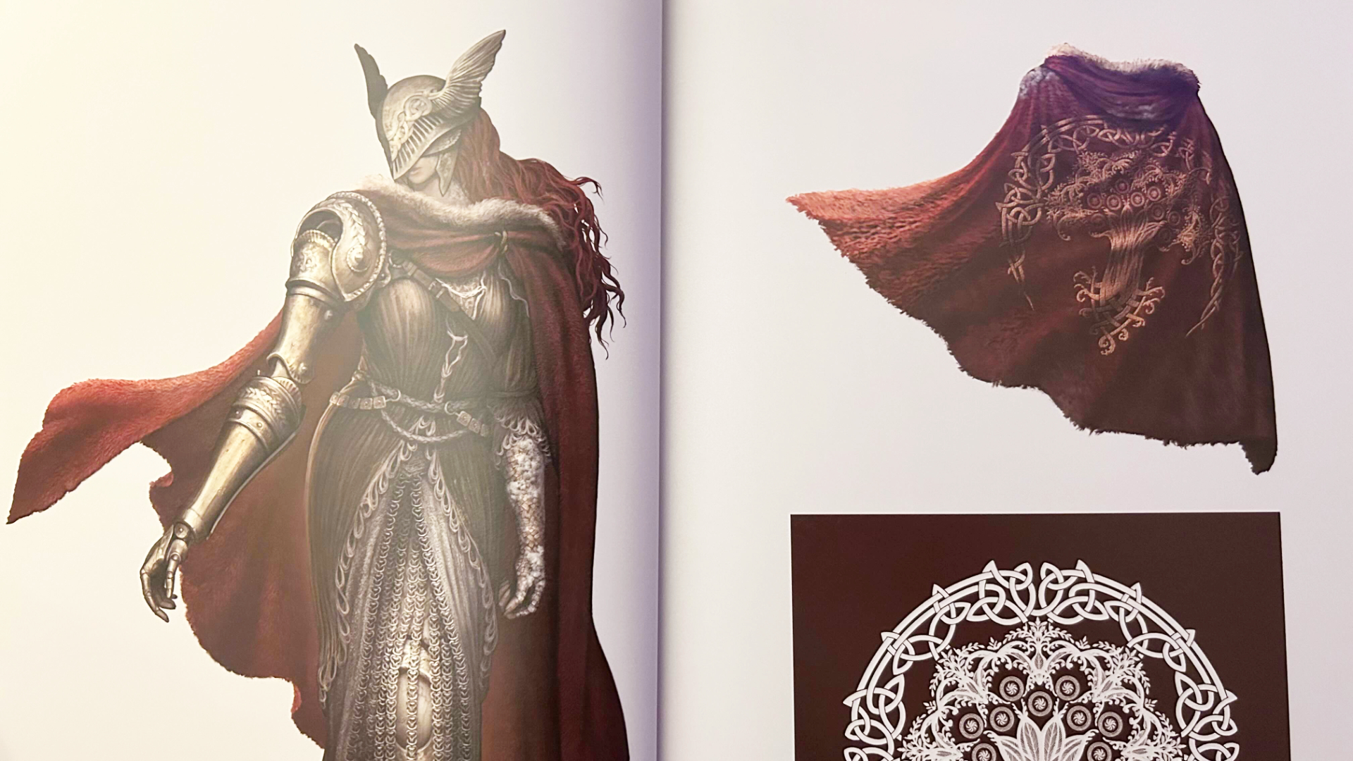 A photo of an Elden Ring concept art book. A red-haired valkyrie woman with metal prosthetics and a red cape is drawn on the left page. On the right is a detailed look at her cape and part of an insignia.