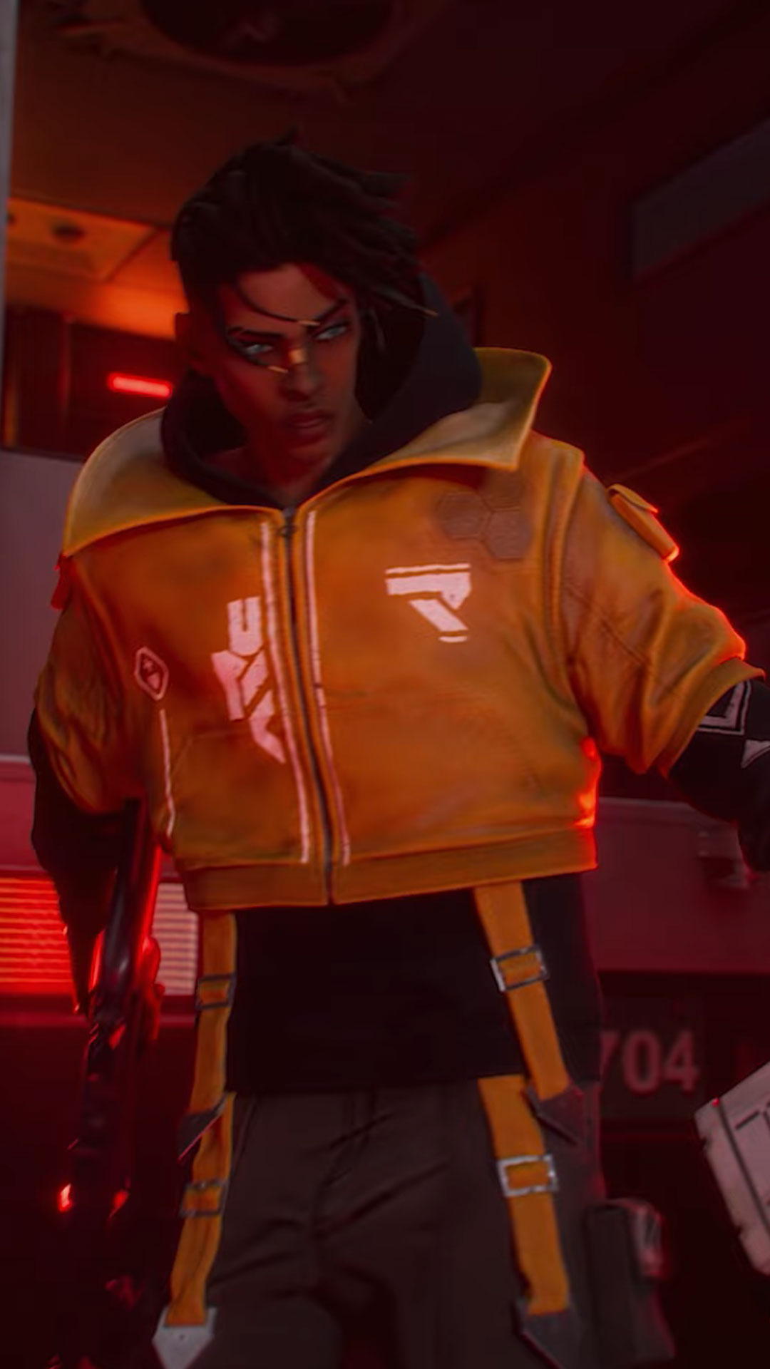 PUBG cinematic trailer character in a yellow hoodie holding a gun in a dim, red-lit room