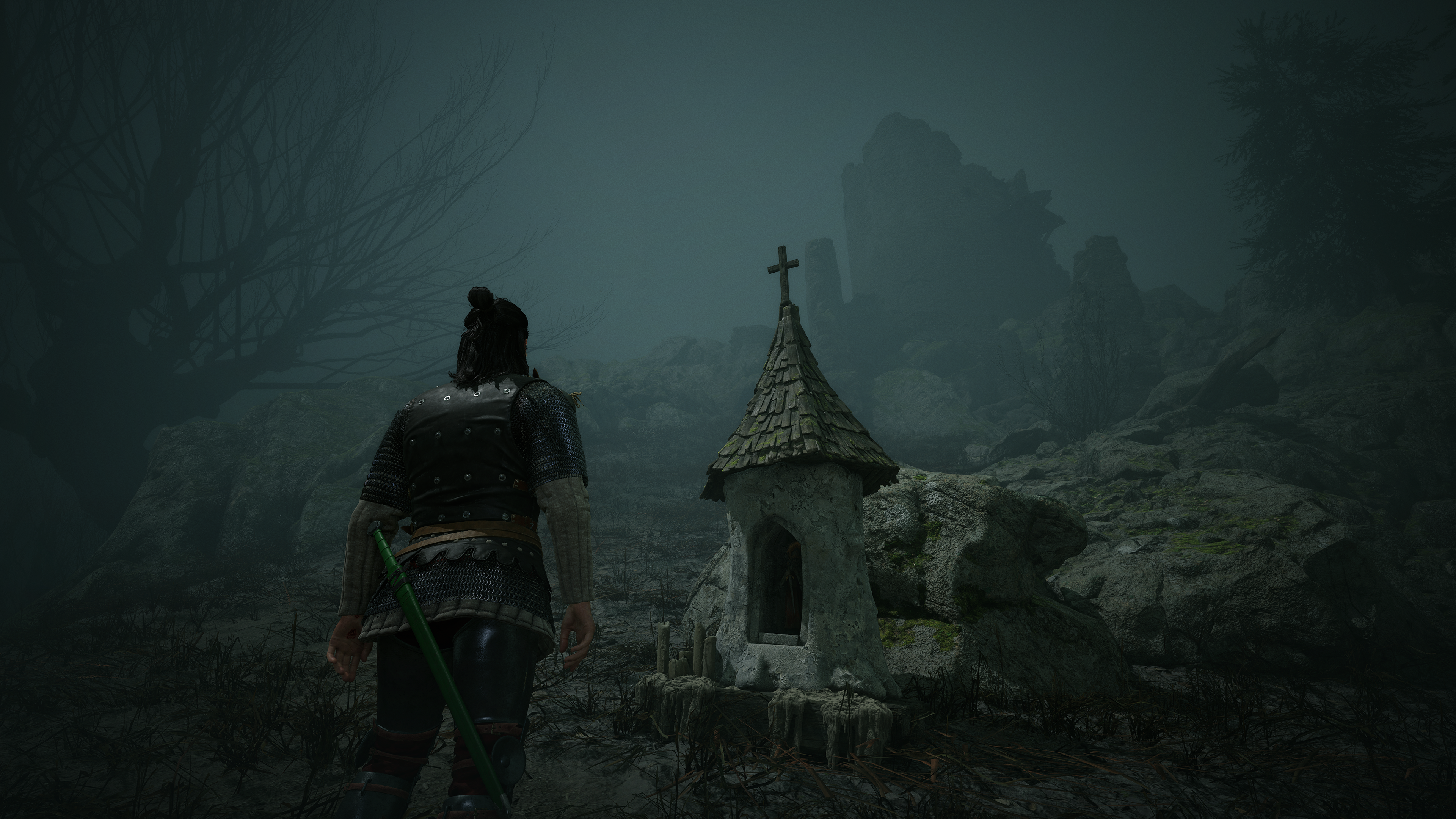 Coen standing in front of a shrine in a misty area in The Blood of Dawnwalker.