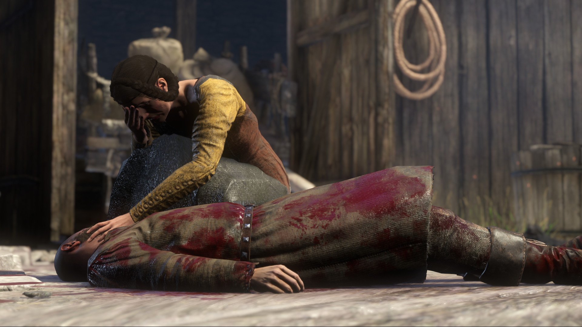 Woman weeps over corpse.