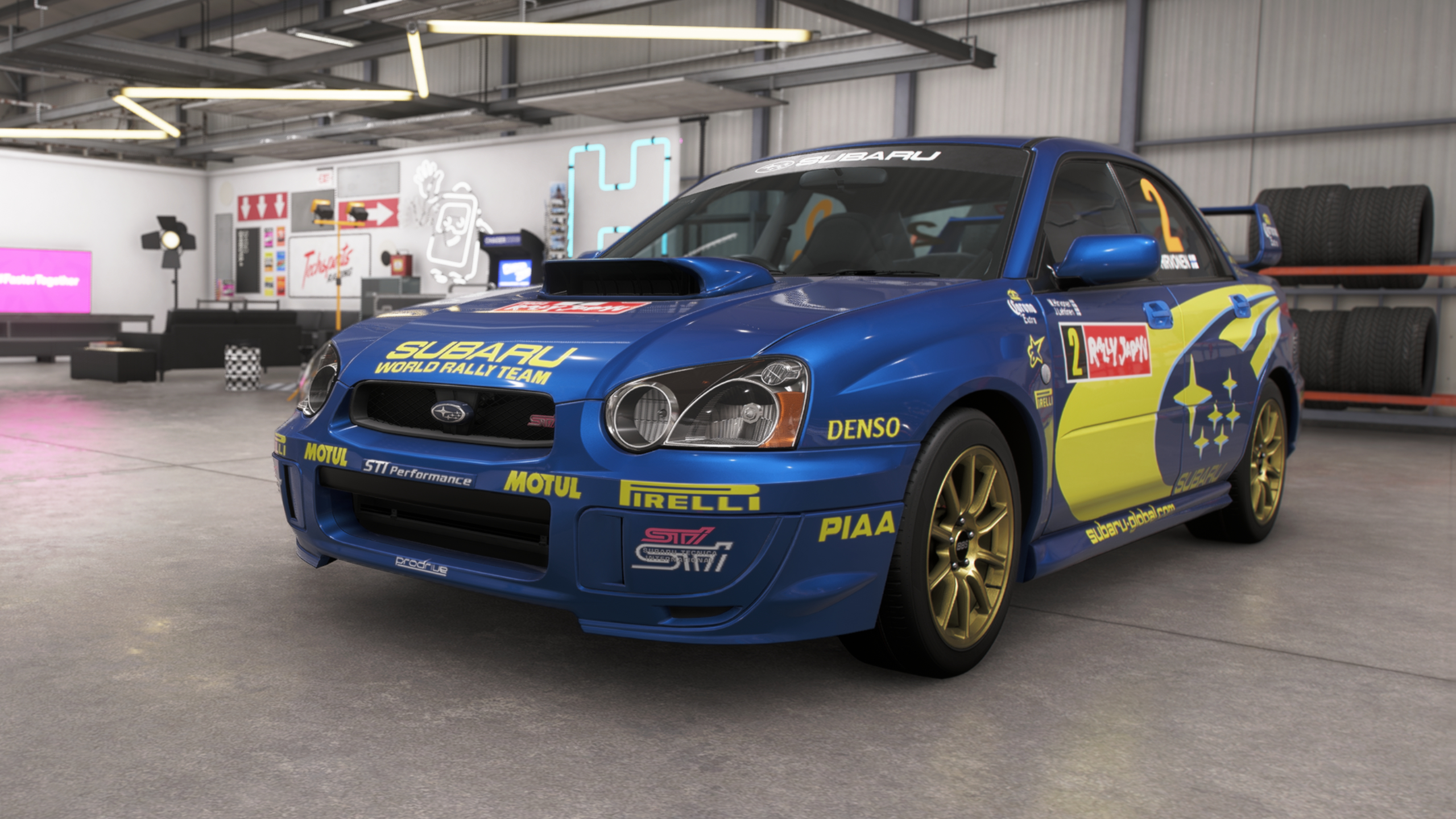 Forza Horizon 6 best cars: The 2004 Subaru Impreza WRX STI in a classic blue and yellow paintjob in a player's garage.