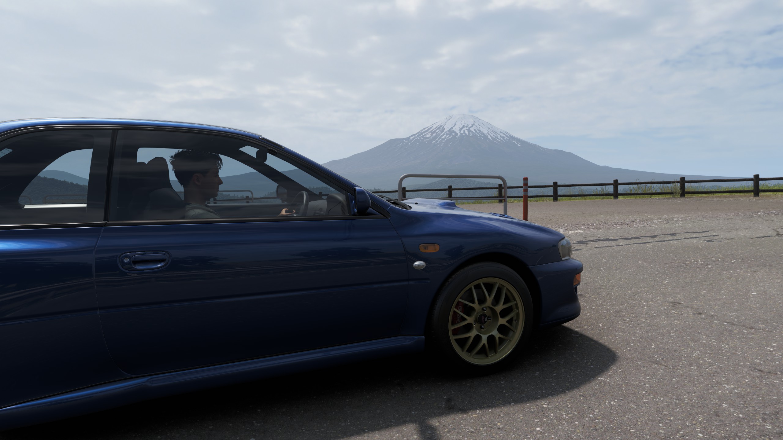 A car driving with Mount Fuji in the background.