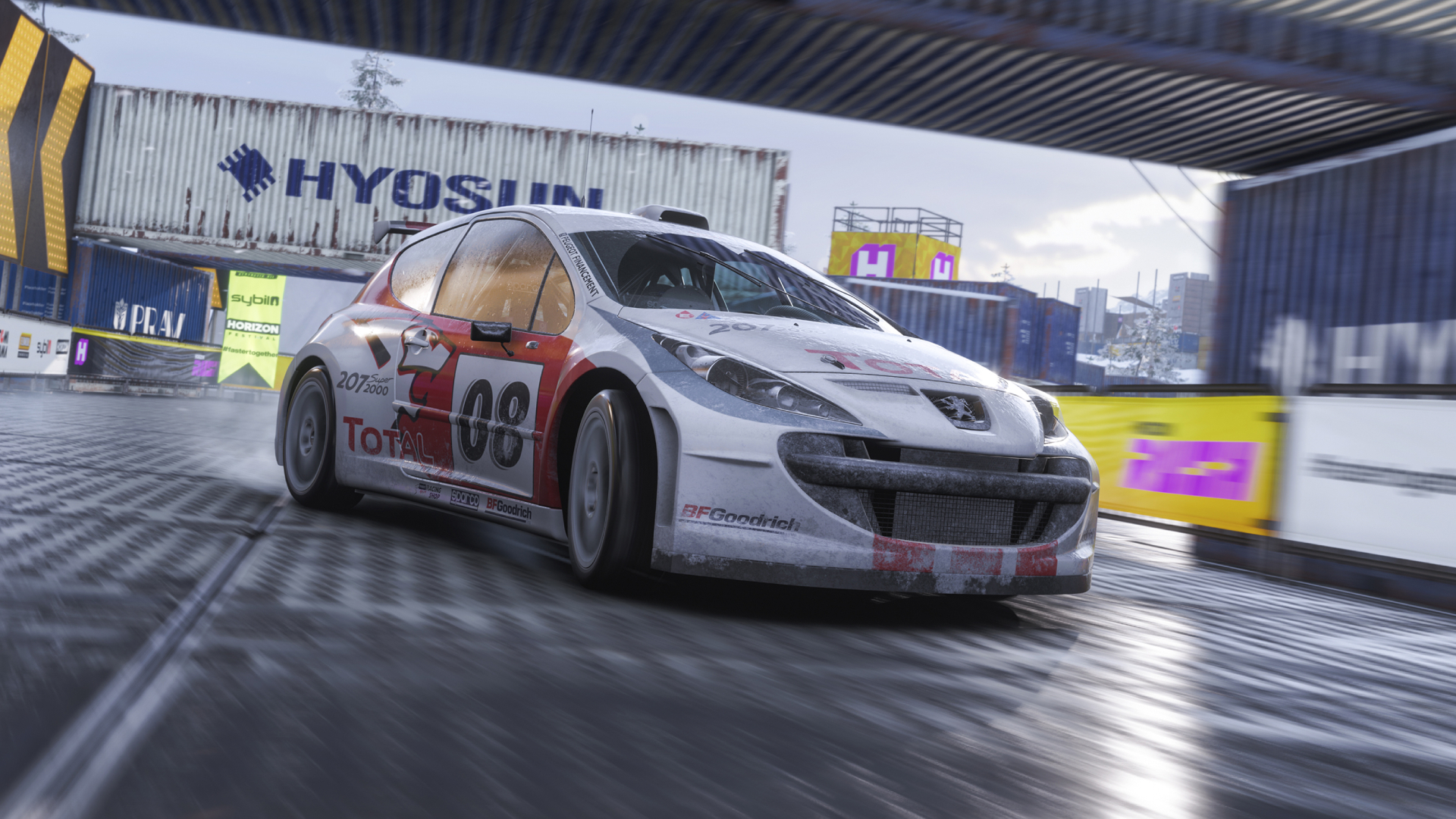 Forza Horizon 6 launch time date: A rally car riding through a track with shipping containers.