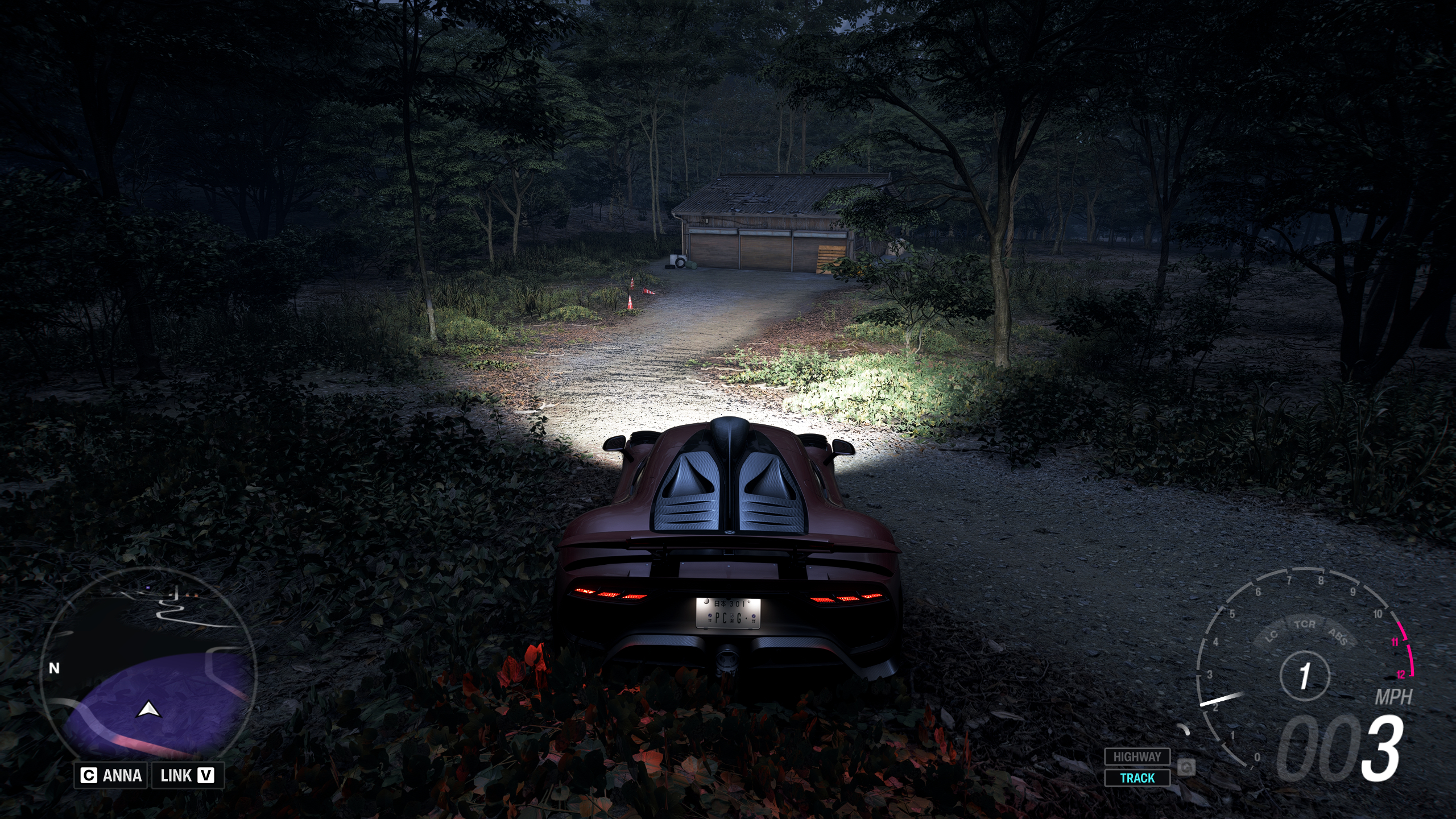 Forza Horizon 6 Barn Finds: A player parked outside an old wooden barn on a wooded hillside at night.