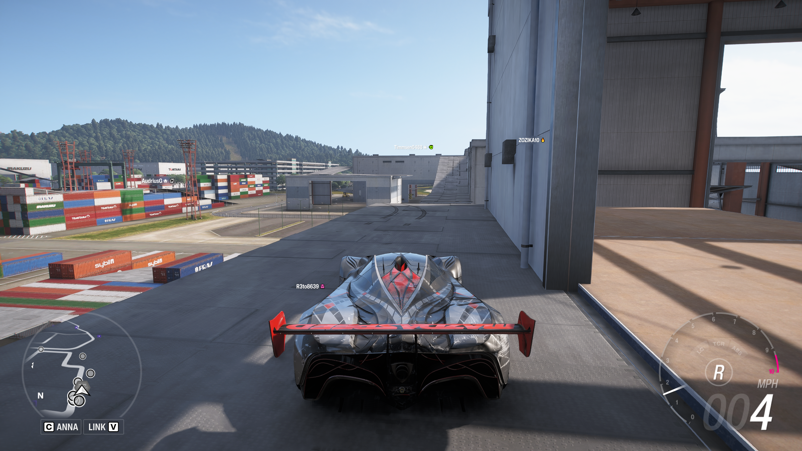 Forza Horizon 6 Tokyo City Treasure Hunt location: A Mazda Furai parked on a balcony on the side of a warehouse, overlooking the dock area.