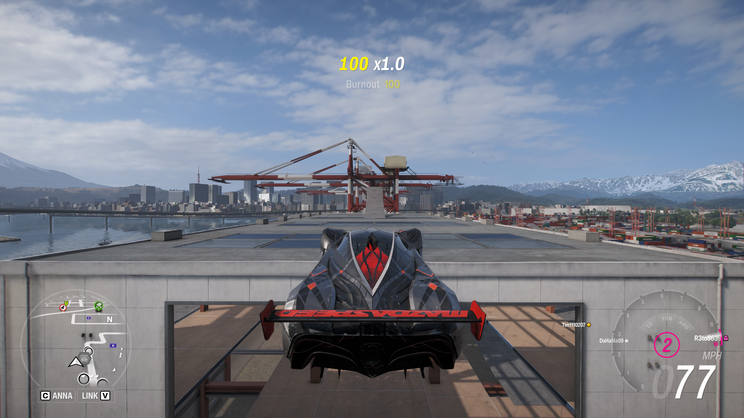 Forza Horizon 6 Tokyo City Treasure Hunt location: A Mazda Furai driving across a gap between two warehouses.