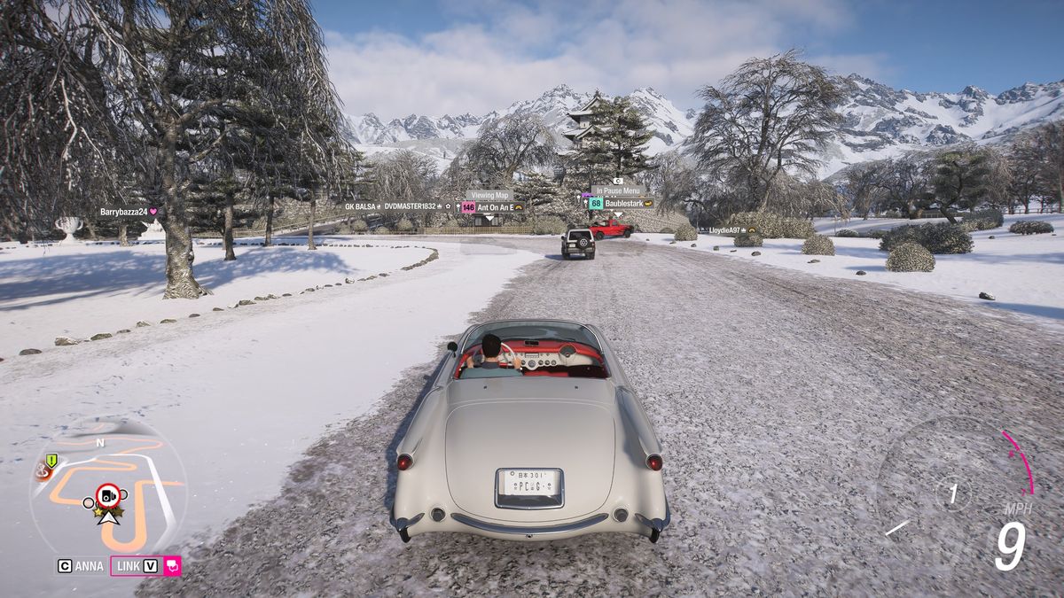 Forza Horizon 6 Hirosaki Castle location: A classic white Chevrolet driving up the path leading to the snow-covered Hirosaki Castle.