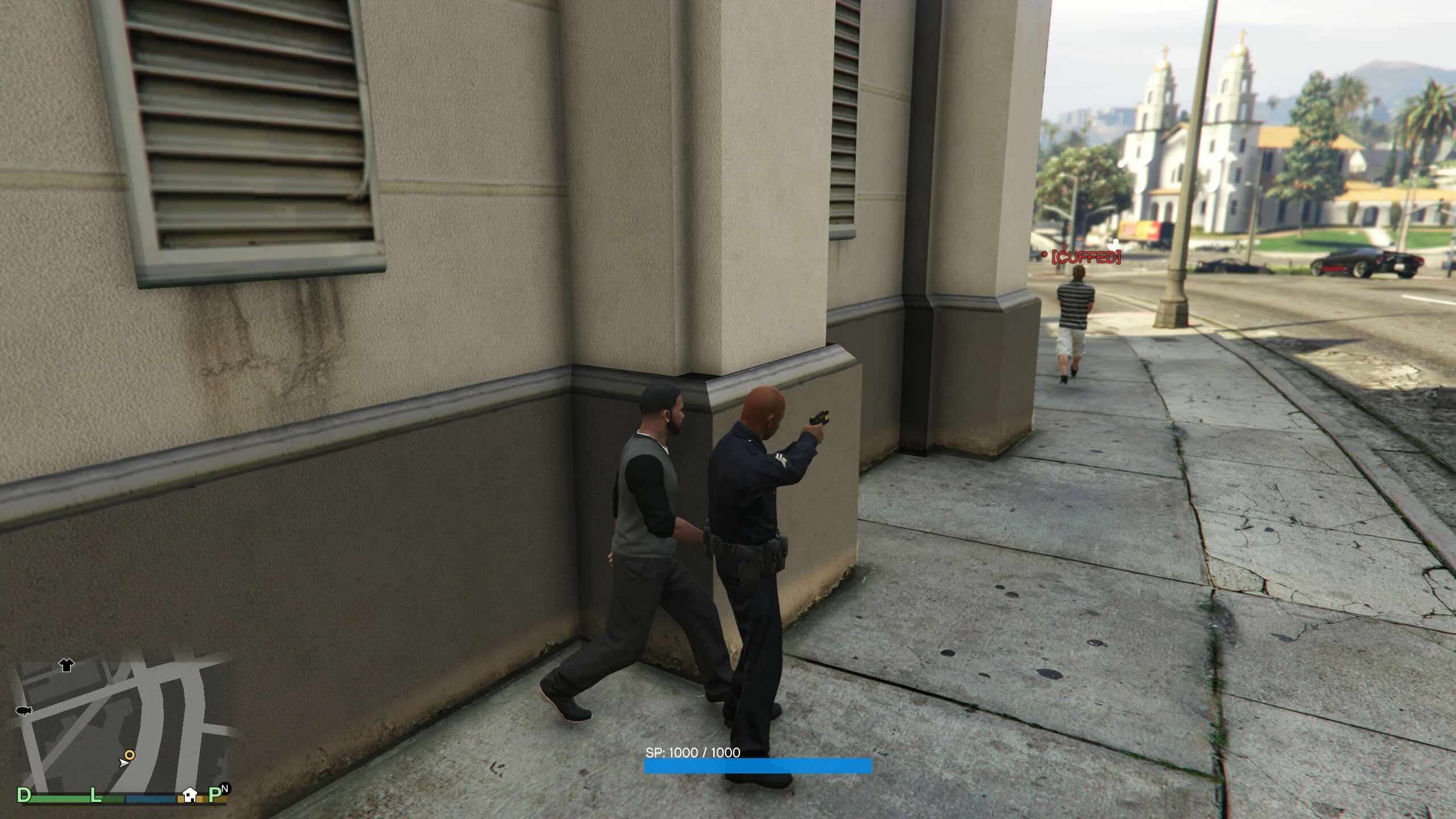 A cop looks on as a cuffed suspect wanders off.